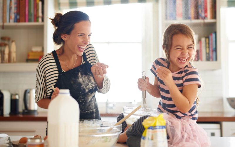 Shot of a little girl having fun baking with her mother in the kitchen